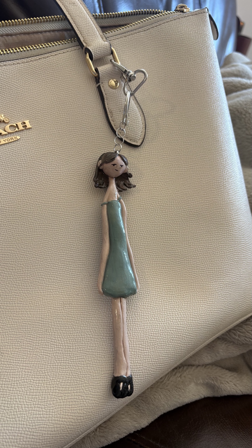 Original lifestyle image of Pay No Mind Mini on purse