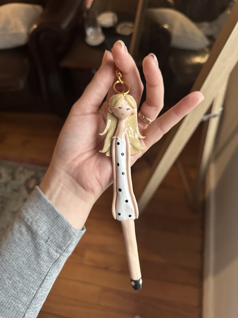 Blonde Original Mini in a white polka-dot dress with gold hardware