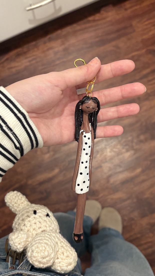 Deep-skin Mini with black hair and polka-dot dress